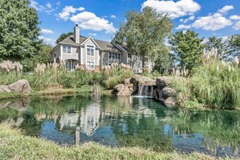 A pond with a house in the back